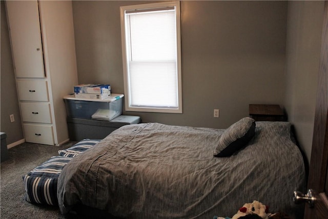 bedroom featuring carpet floors and baseboards