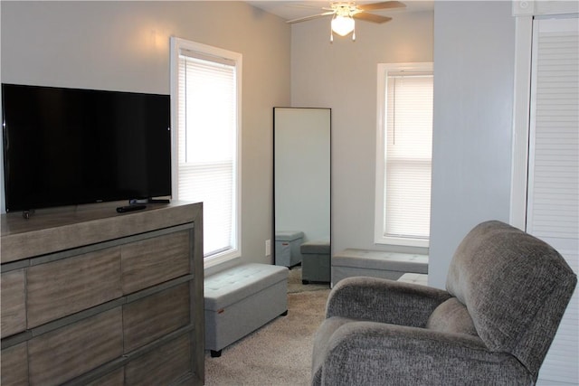 sitting room featuring ceiling fan and light colored carpet