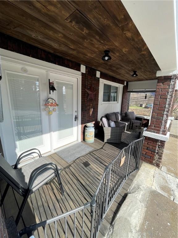 view of patio with outdoor lounge area and a wall mounted air conditioner