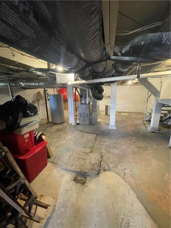 unfinished below grade area with heating unit and water heater