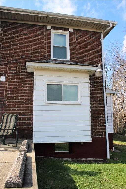 view of side of property featuring brick siding