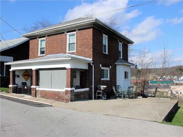 view of front of property with brick siding and covered porch