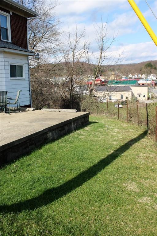 view of grassy yard featuring a wooden deck