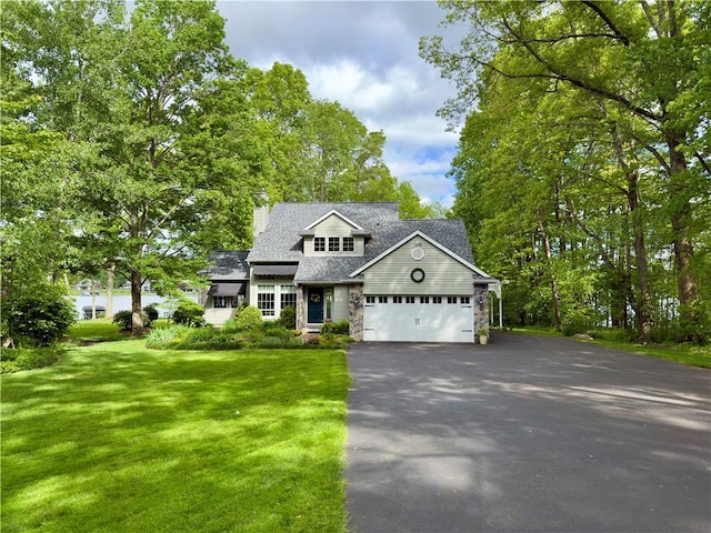 788 Latonka Dr, Coolspring Twp, PA 16137 - view of front of house with driveway, a front lawn, stone siding, an attached garage, and a shingled roof