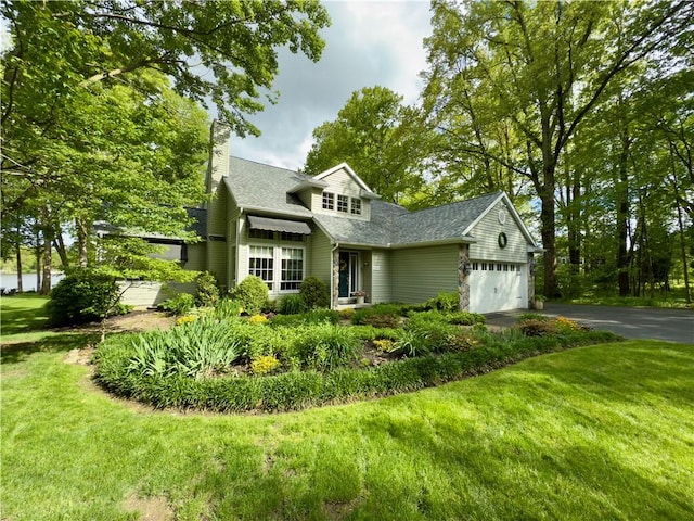 788 Latonka Dr, Coolspring Twp, PA 16137 - traditional-style house featuring asphalt driveway, a front yard, a chimney, and an attached garage