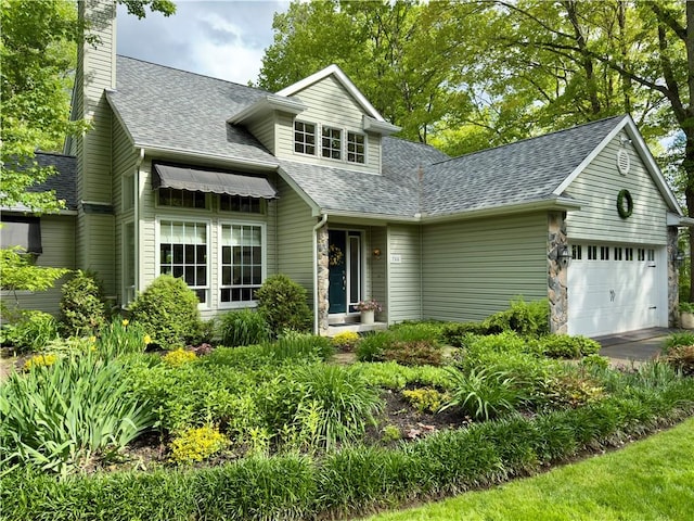 788 Latonka Dr, Coolspring Twp, PA 16137 - view of front facade featuring a chimney, roof with shingles, a garage, driveway, and stone siding