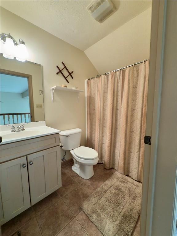 788 Latonka Dr, Coolspring Twp, PA 16137 - full bathroom with toilet, tile patterned flooring, vanity, and lofted ceiling
