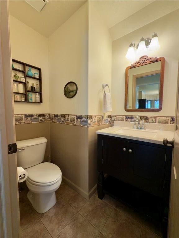 788 Latonka Dr, Coolspring Twp, PA 16137 - bathroom featuring vanity, toilet, tile patterned flooring, tile walls, and a wainscoted wall