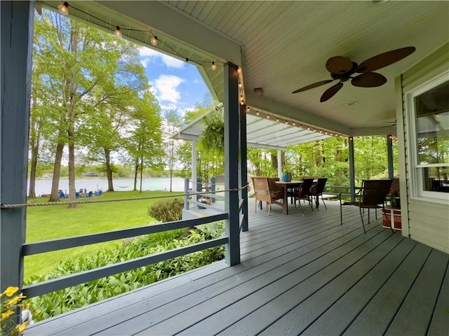 788 Latonka Dr, Coolspring Twp, PA 16137 - deck with a water view, a ceiling fan, outdoor dining space, and a lawn