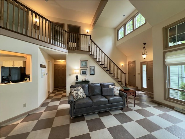 788 Latonka Dr, Coolspring Twp, PA 16137 - living room featuring healthy amount of natural light, stairway, a high ceiling, tile patterned floors, and baseboards