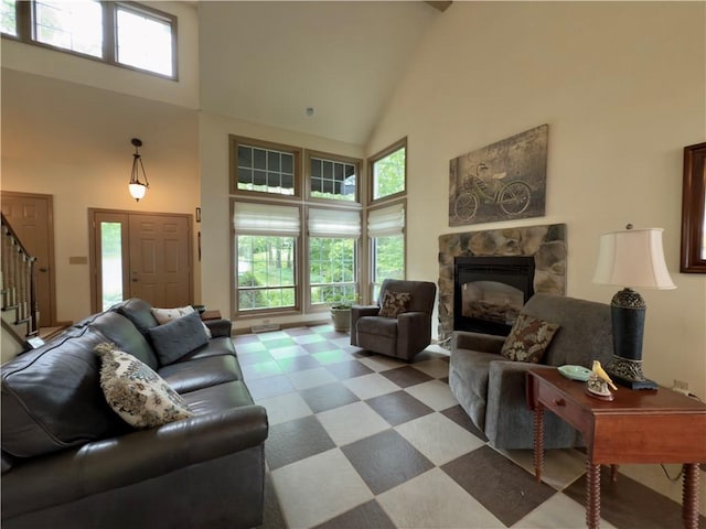 788 Latonka Dr, Coolspring Twp, PA 16137 - living room with high vaulted ceiling, stairs, and a stone fireplace
