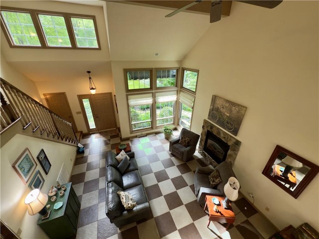 788 Latonka Dr, Coolspring Twp, PA 16137 - living room with high vaulted ceiling, healthy amount of natural light, stairway, a ceiling fan, and a glass covered fireplace