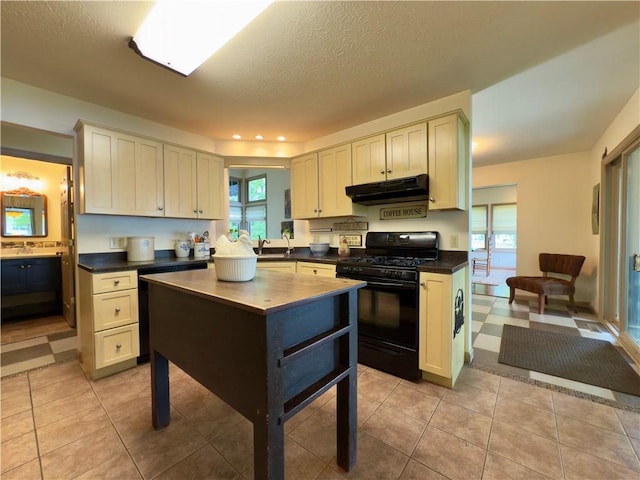788 Latonka Dr, Coolspring Twp, PA 16137 - kitchen featuring black gas stove, under cabinet range hood, dark countertops, a sink, and a textured ceiling