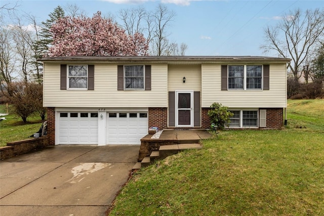 raised ranch with concrete driveway, brick siding, a garage, and a front lawn