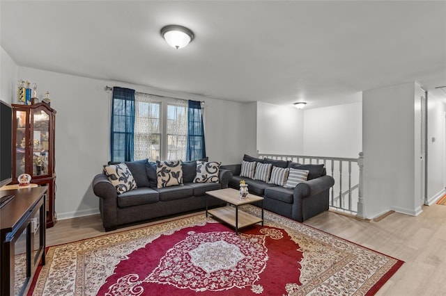 living area featuring wood finished floors and baseboards