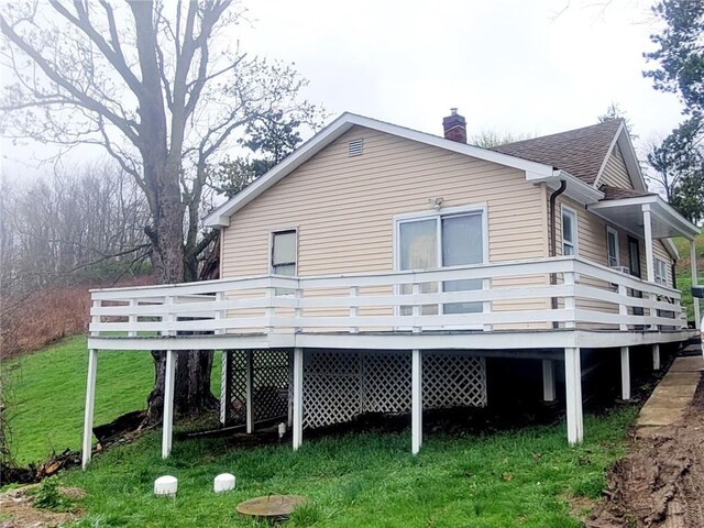 11 Murner Ln, Claysville, PA 15323 - rear view of property with a wooden deck, a lawn, and a chimney