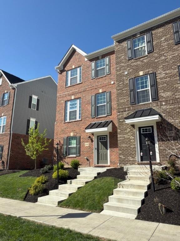 townhome / multi-family property with brick siding