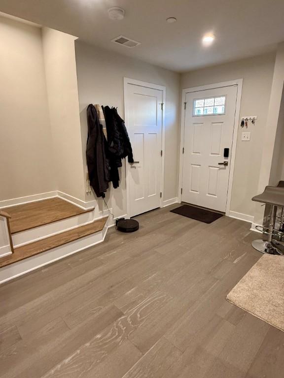 entrance foyer with wood finished floors, recessed lighting, visible vents, and baseboards