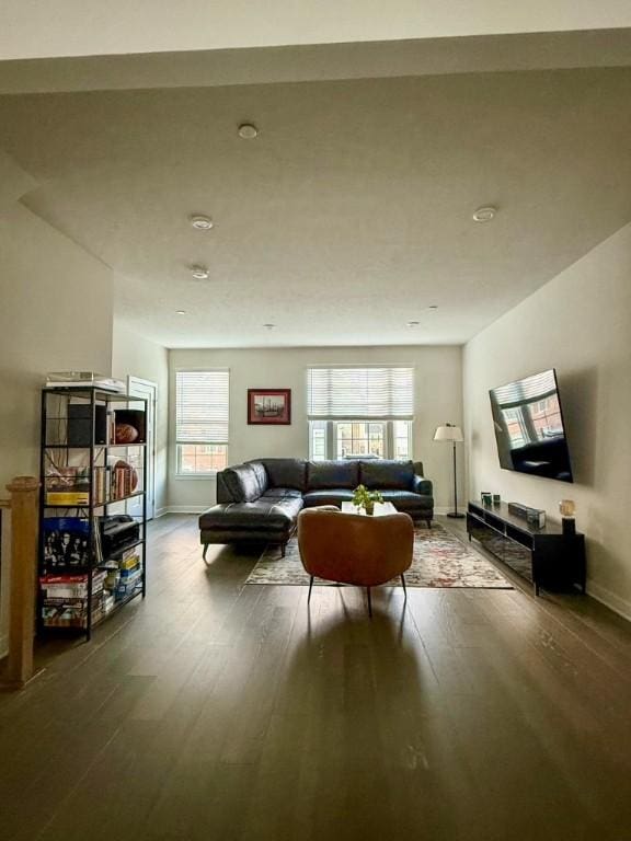 living area with wood finished floors and baseboards