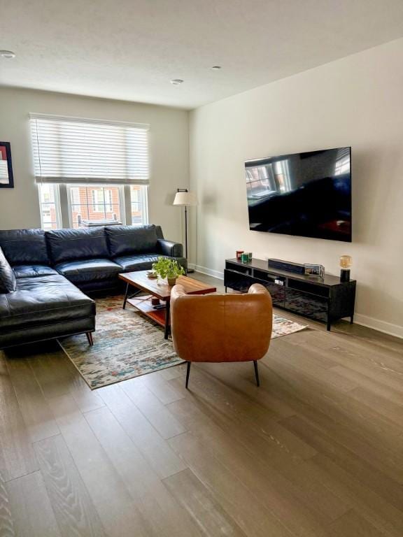 living room with wood finished floors and baseboards