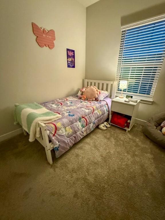 carpeted bedroom featuring baseboards