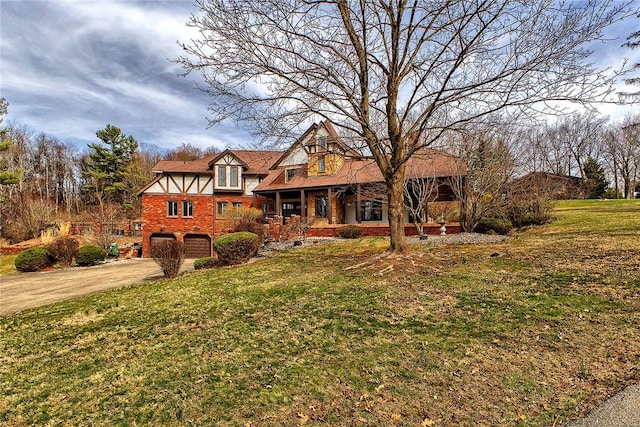 view of front of property featuring a front lawn, an attached garage, driveway, and a porch