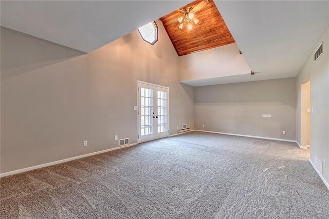 unfurnished room with high vaulted ceiling, visible vents, wooden ceiling, and french doors