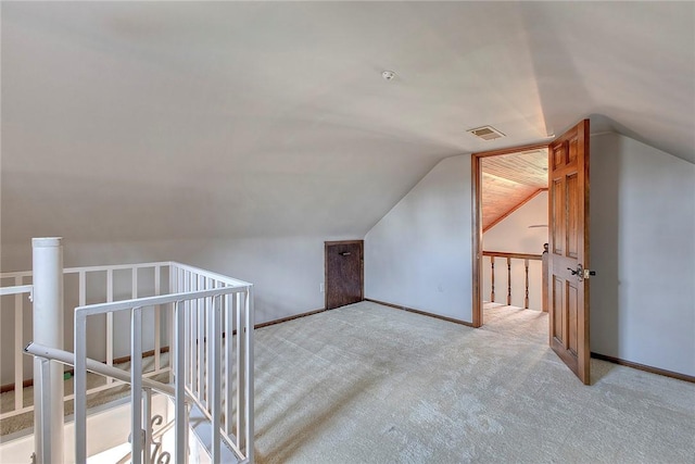 bonus room featuring light carpet, baseboards, vaulted ceiling, and visible vents