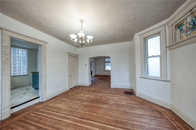 1223 Chelton Ave, Brookline, PA 15226 - unfurnished dining area with an inviting chandelier, wood finished floors, baseboards, and arched walkways