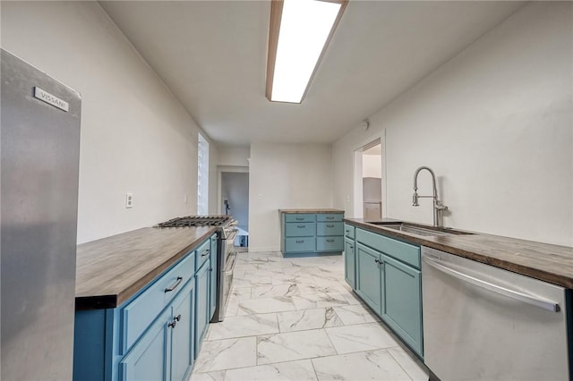 1223 Chelton Ave, Brookline, PA 15226 - kitchen with blue cabinetry, wood counters, appliances with stainless steel finishes, and a sink