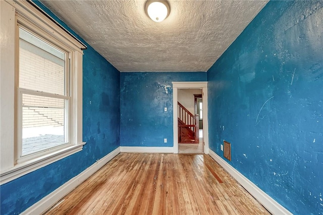 1223 Chelton Ave, Brookline, PA 15226 - unfurnished room featuring baseboards, hardwood / wood-style floors, a textured ceiling, and stairs