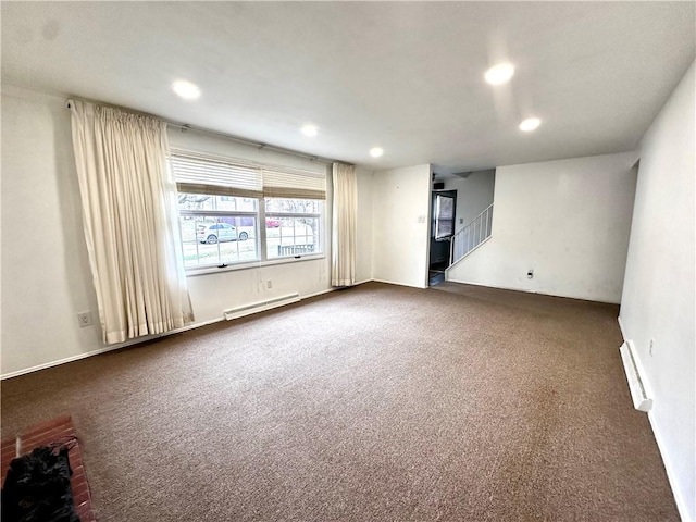 empty room featuring a baseboard radiator, recessed lighting, dark colored carpet, and stairway