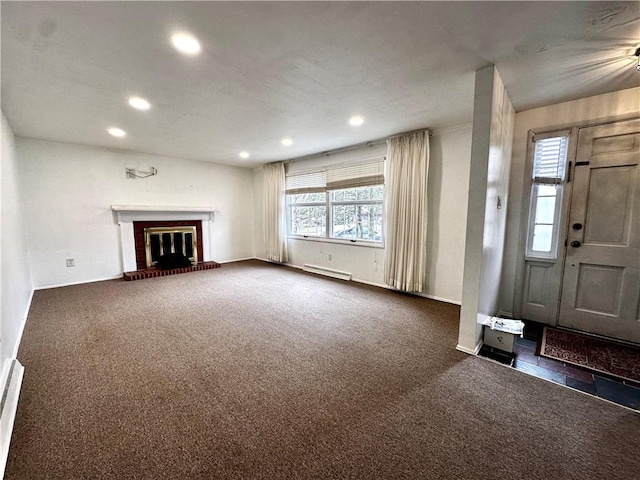 unfurnished living room featuring recessed lighting, carpet, and a brick fireplace