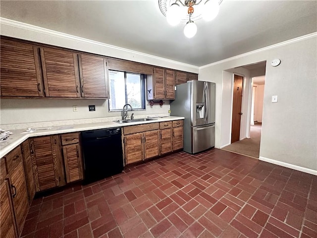 kitchen featuring light countertops, dishwasher, a sink, and stainless steel fridge