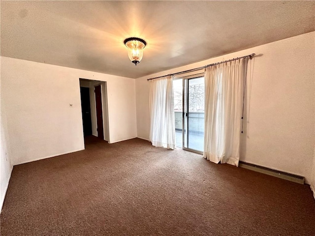 unfurnished room with baseboard heating and dark colored carpet