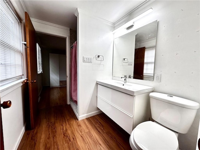 full bathroom with baseboards, toilet, crown molding, vanity, and wood finished floors