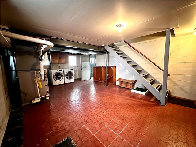 basement with tile patterned floors, washer and clothes dryer, and stairway