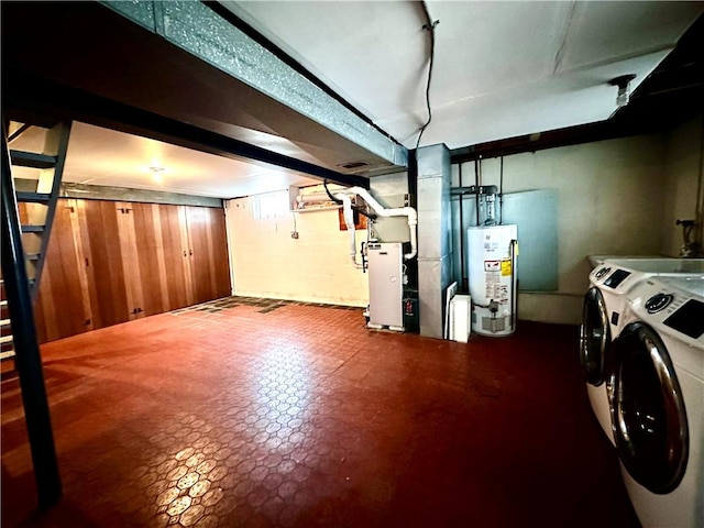 finished below grade area with washing machine and clothes dryer, heating unit, and water heater