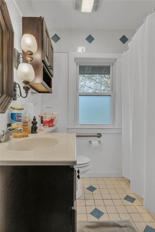 338 4th St, Beaver, PA 15009 - full bath with tile patterned flooring, vanity, visible vents, and toilet