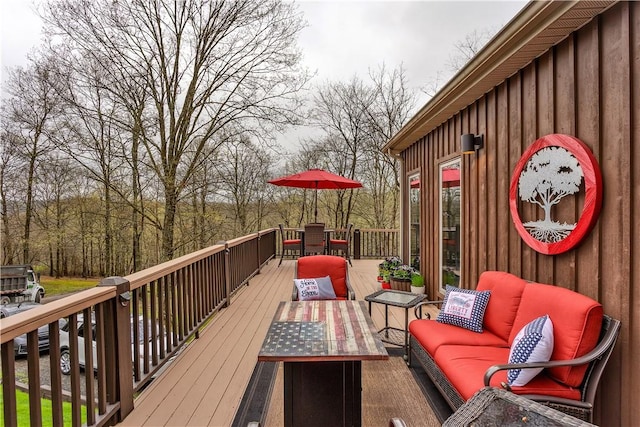 wooden deck with outdoor dining space and outdoor lounge area
