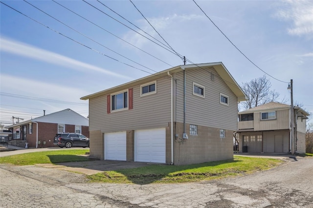 view of property exterior featuring driveway and a garage