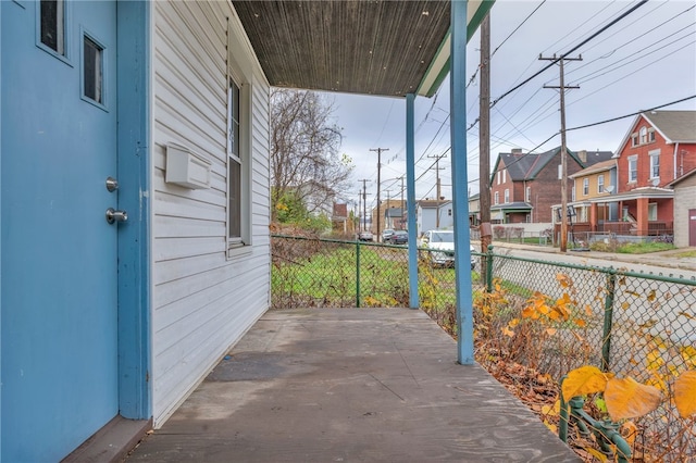 view of patio with fence and a residential view