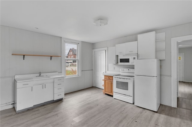 kitchen featuring white cabinets, open shelves, light countertops, light wood-type flooring, and white appliances