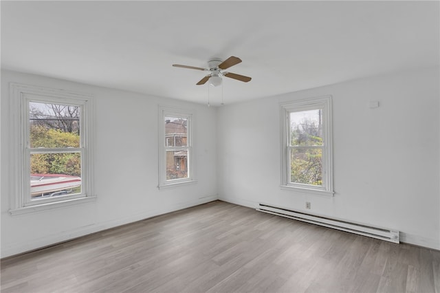 unfurnished room featuring a baseboard radiator, a ceiling fan, and wood finished floors