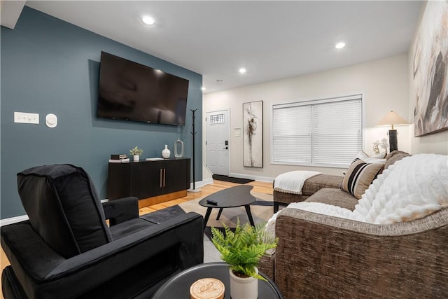 living room featuring baseboards, recessed lighting, and wood finished floors