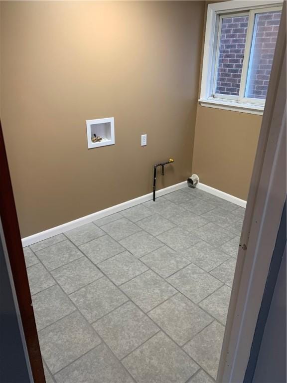washroom featuring baseboards, laundry area, and washer hookup