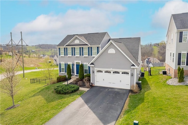view of front of house featuring cooling unit, aphalt driveway, a front yard, a garage, and fence