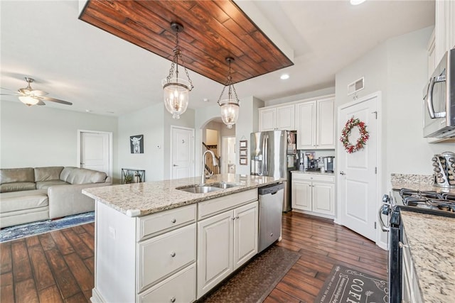 kitchen featuring ceiling fan, white cabinets, visible vents, a sink, and stainless steel appliances