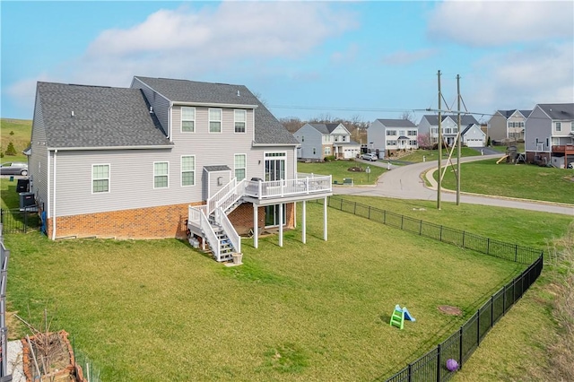 exterior space featuring stairway, a deck, a residential view, and fence private yard