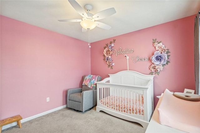 carpeted bedroom featuring ceiling fan, baseboards, and a nursery area